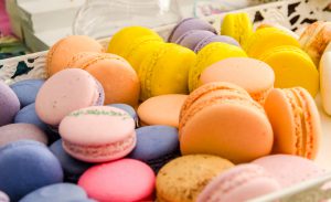 Variety of sweet colorful macaroons lying in a box